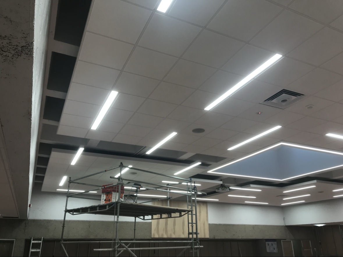 Acoustic tile ceiling installation nearing completion