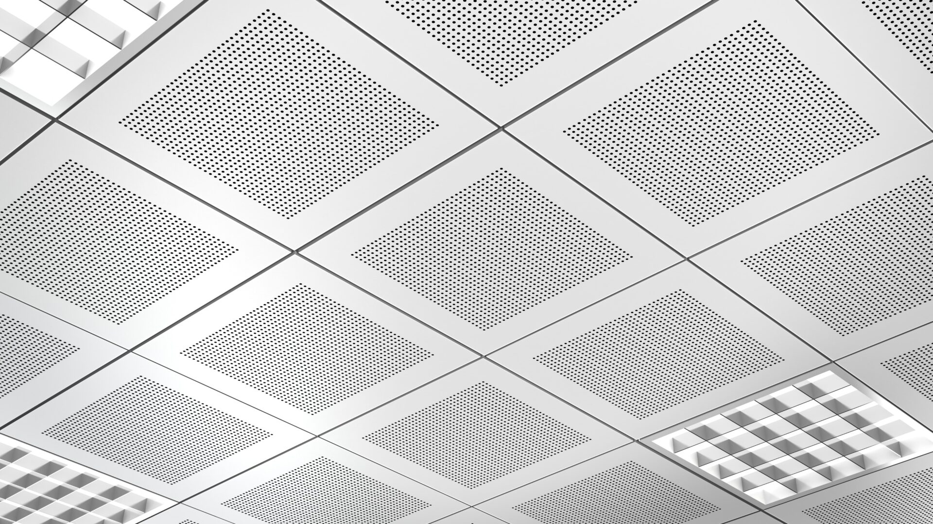 Completed suspended acoustic ceiling system with perforated tiles and integrated lighting